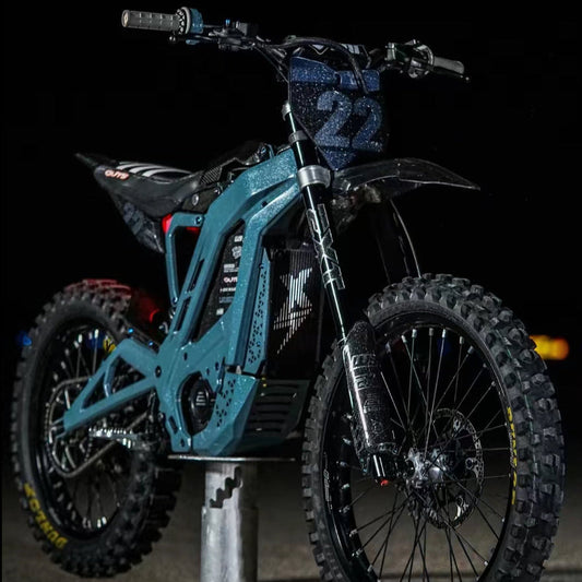 Surron and E-Ride side fender decal installed on blue e-moto at night