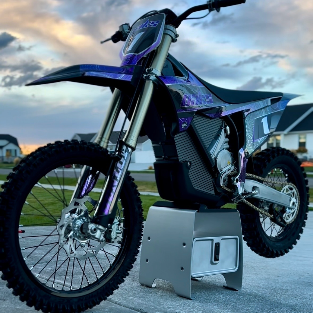 Stark Varg graphics kit installed on blue electric dirt bike