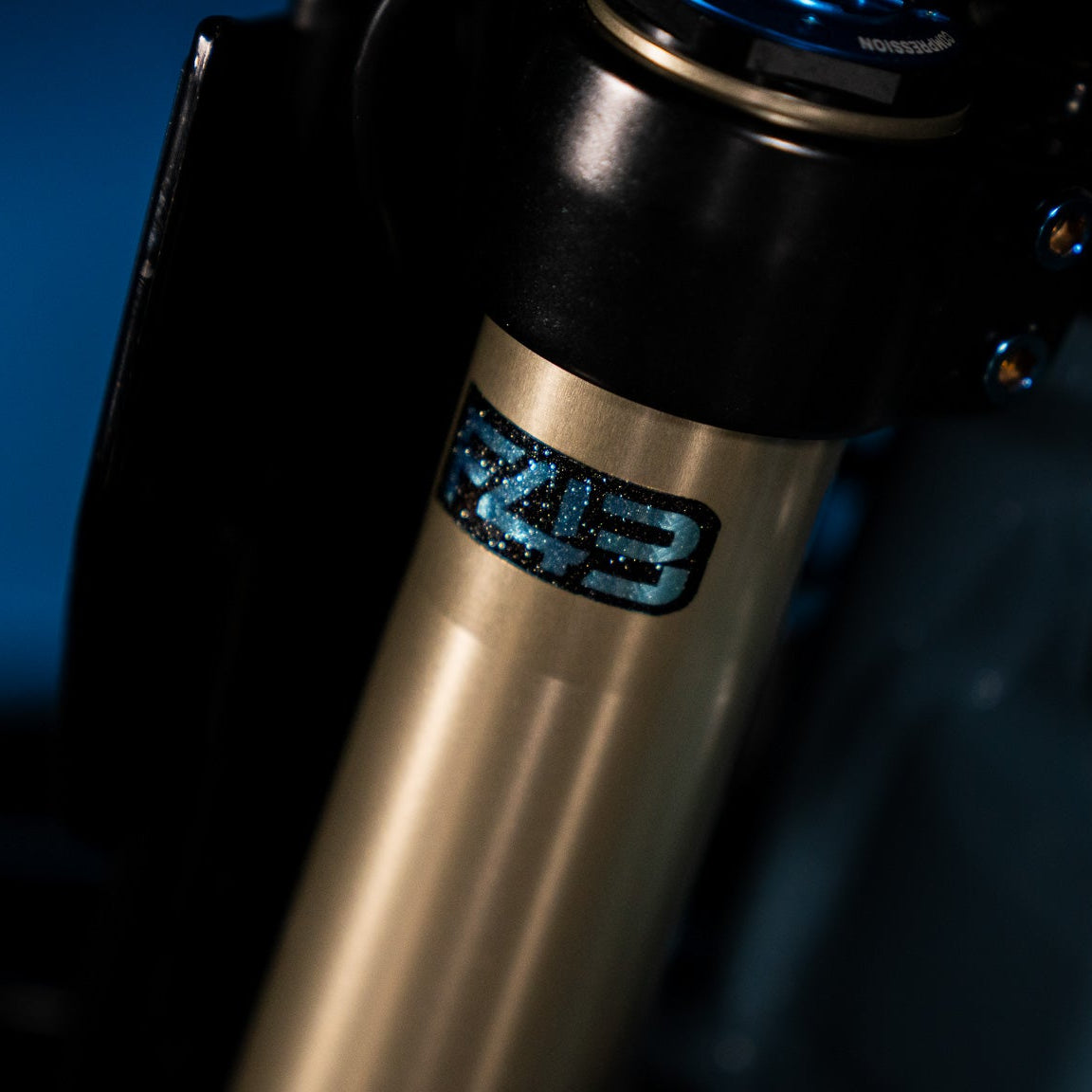 Sirris F43 fork decal installed on blue motorcycle fork