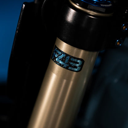 Sirris F43 fork decal installed on blue motorcycle fork