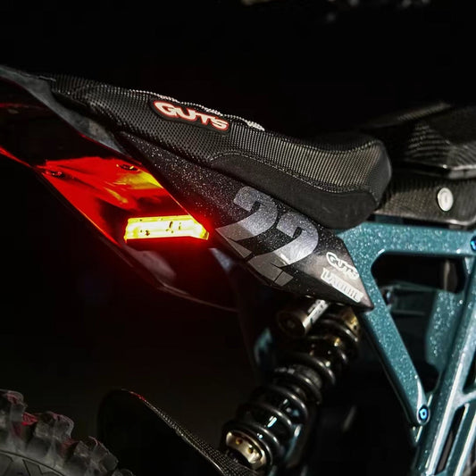 Side fender decal with number 22 installed on a Surron, dark lifestyle shot — Summit MX