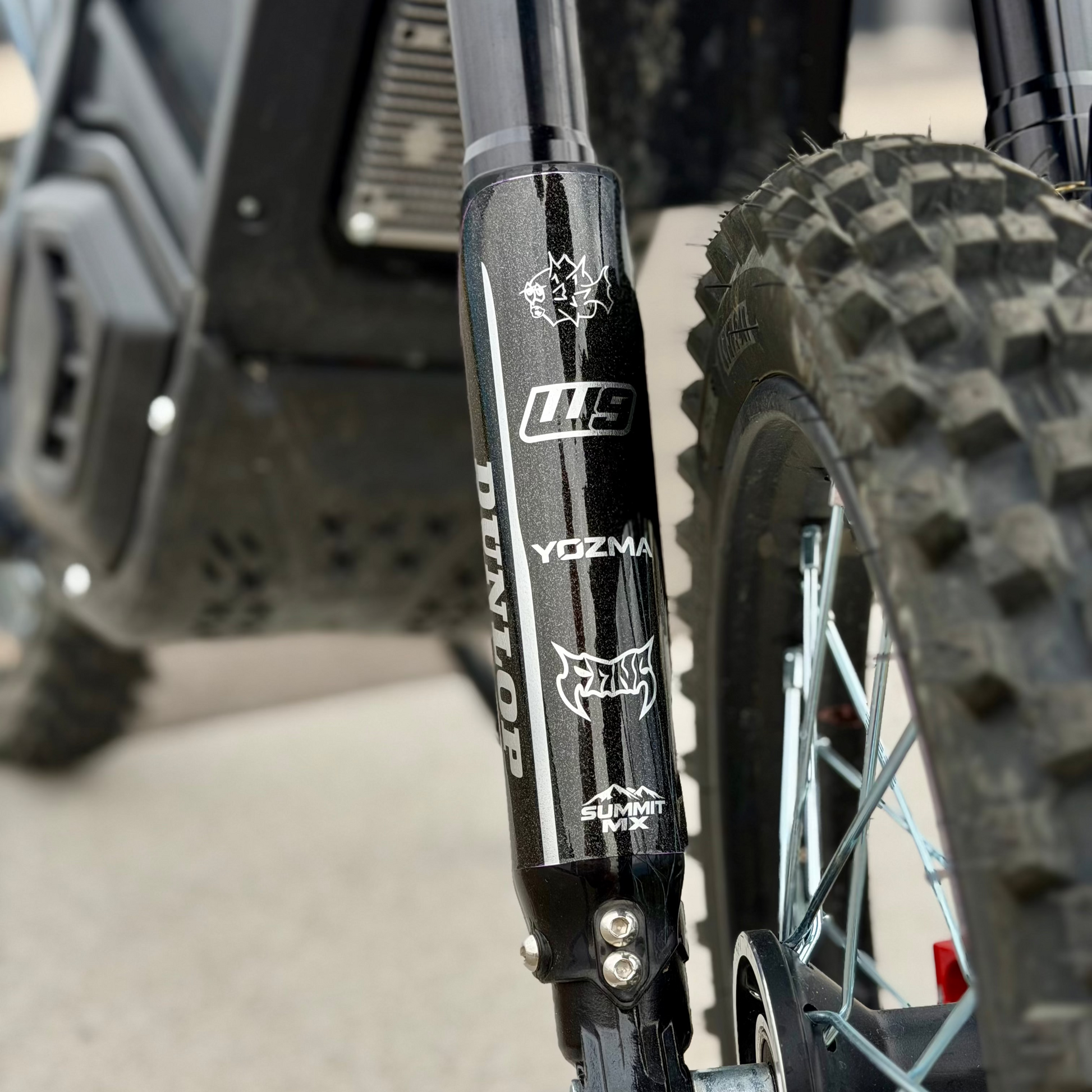 Black and chrome fork guard decals on a Yozma In10 electric motorcycle.